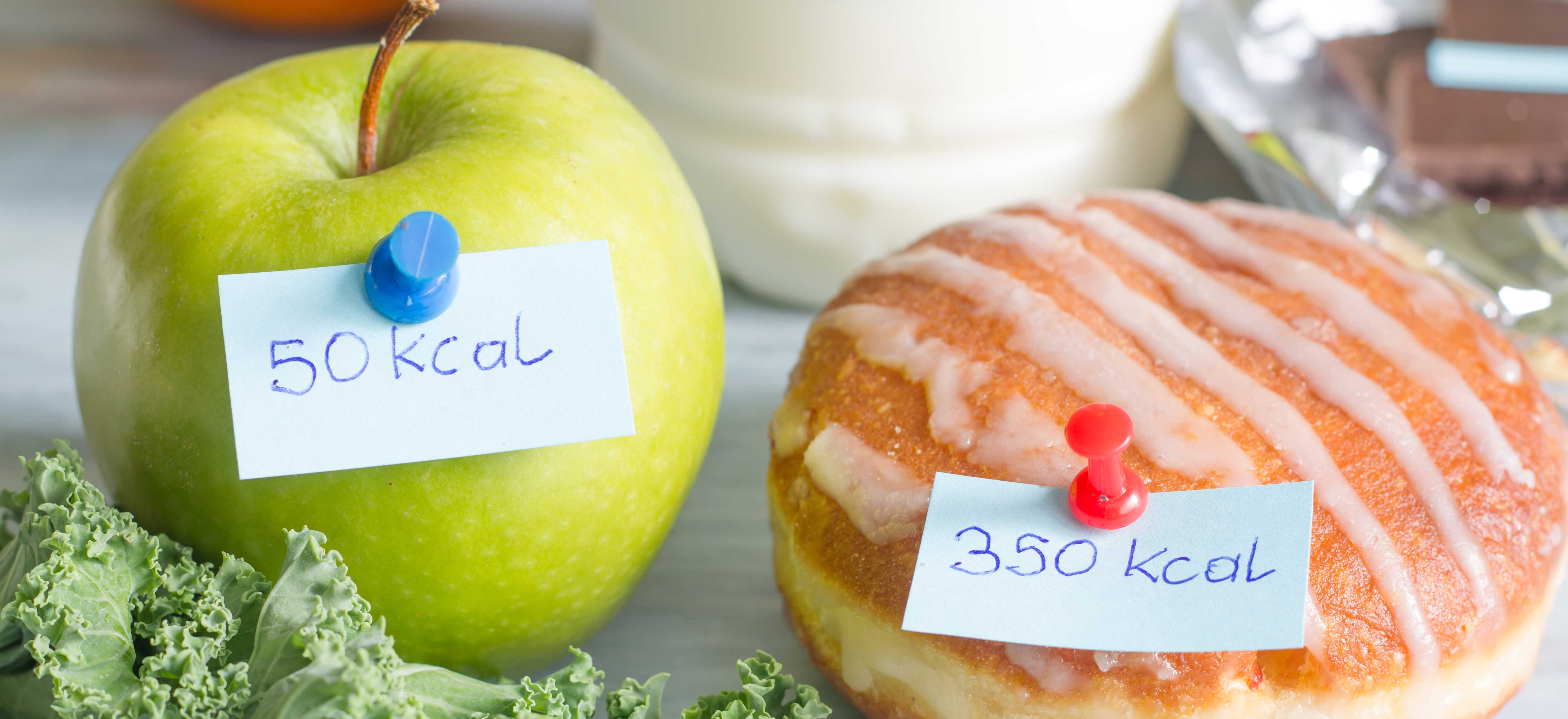 An apple and doughnut with their calorie values pinned to them